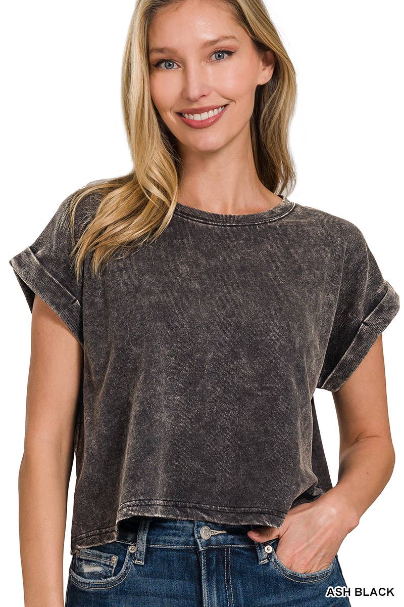 A woman wearing a lavender acid wash cotton folded sleeve top with jeans.