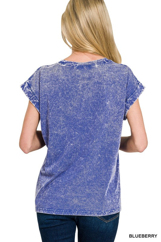 Woman wearing a blue acid-wash t-shirt on a white background