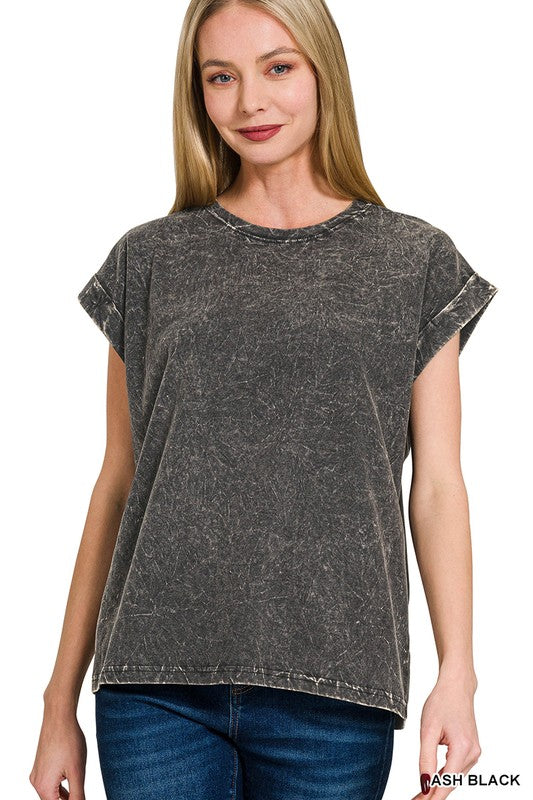 Woman wearing a black acid-wash t-shirt on a white background